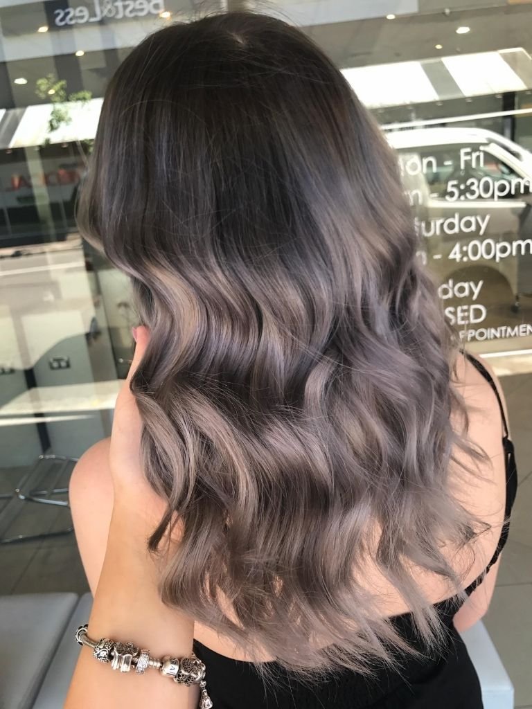 Grey balayage hair color with soft waves, perfect for a stylish look in Sydney CBD.