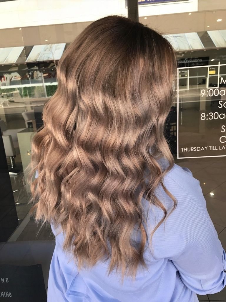 Beautiful long wavy hair styled by a mobile hairdresser in Sydney CBD.